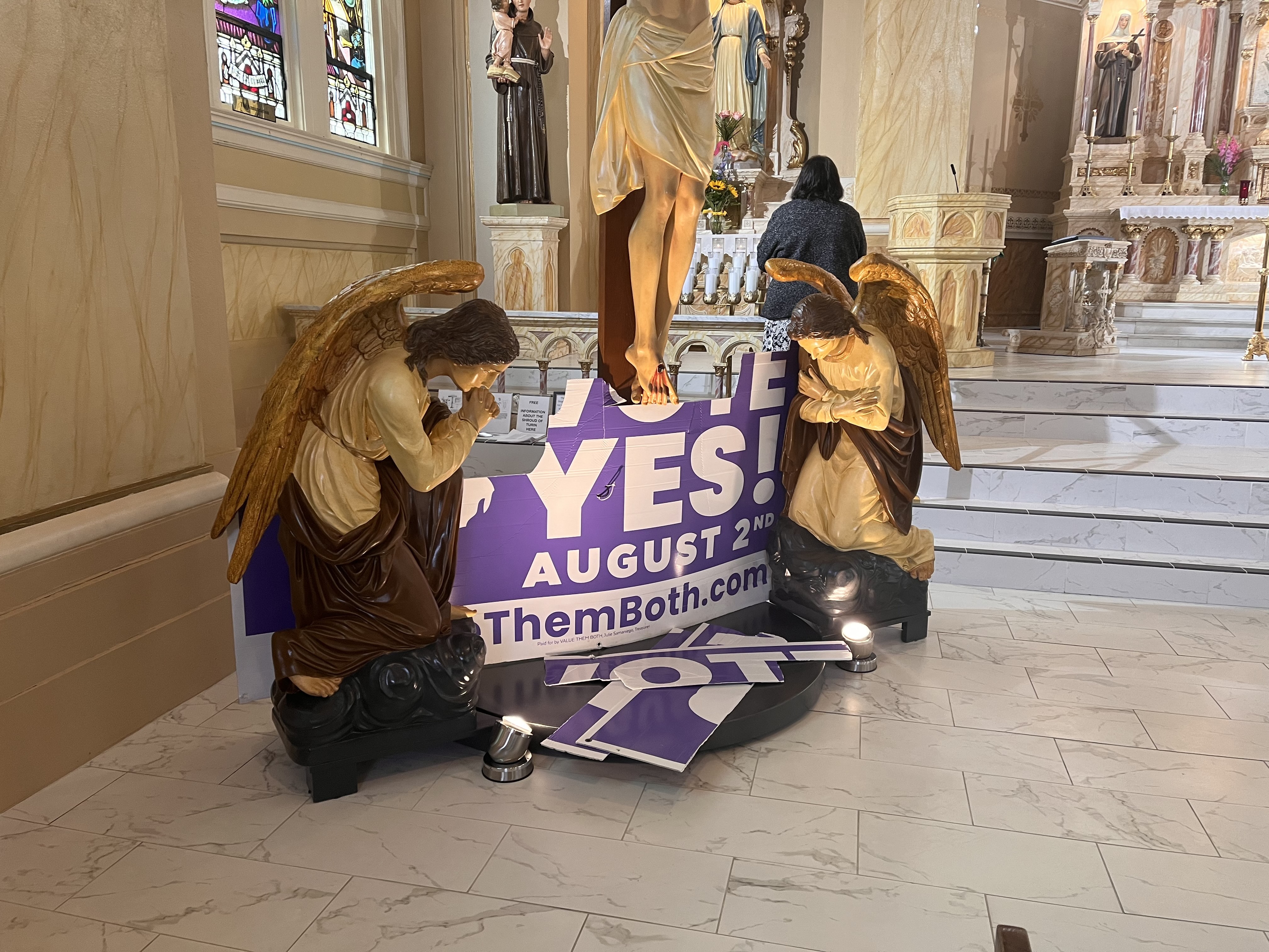 Pieces of a sign promoting the Value Them Both amendment were laid at the foot of the cross within St. Teresa's Catholic Church. Pieces of a sign promoting the Value Them Both amendment were laid at the foot of the cross within St. Teresa's Catholic Church.