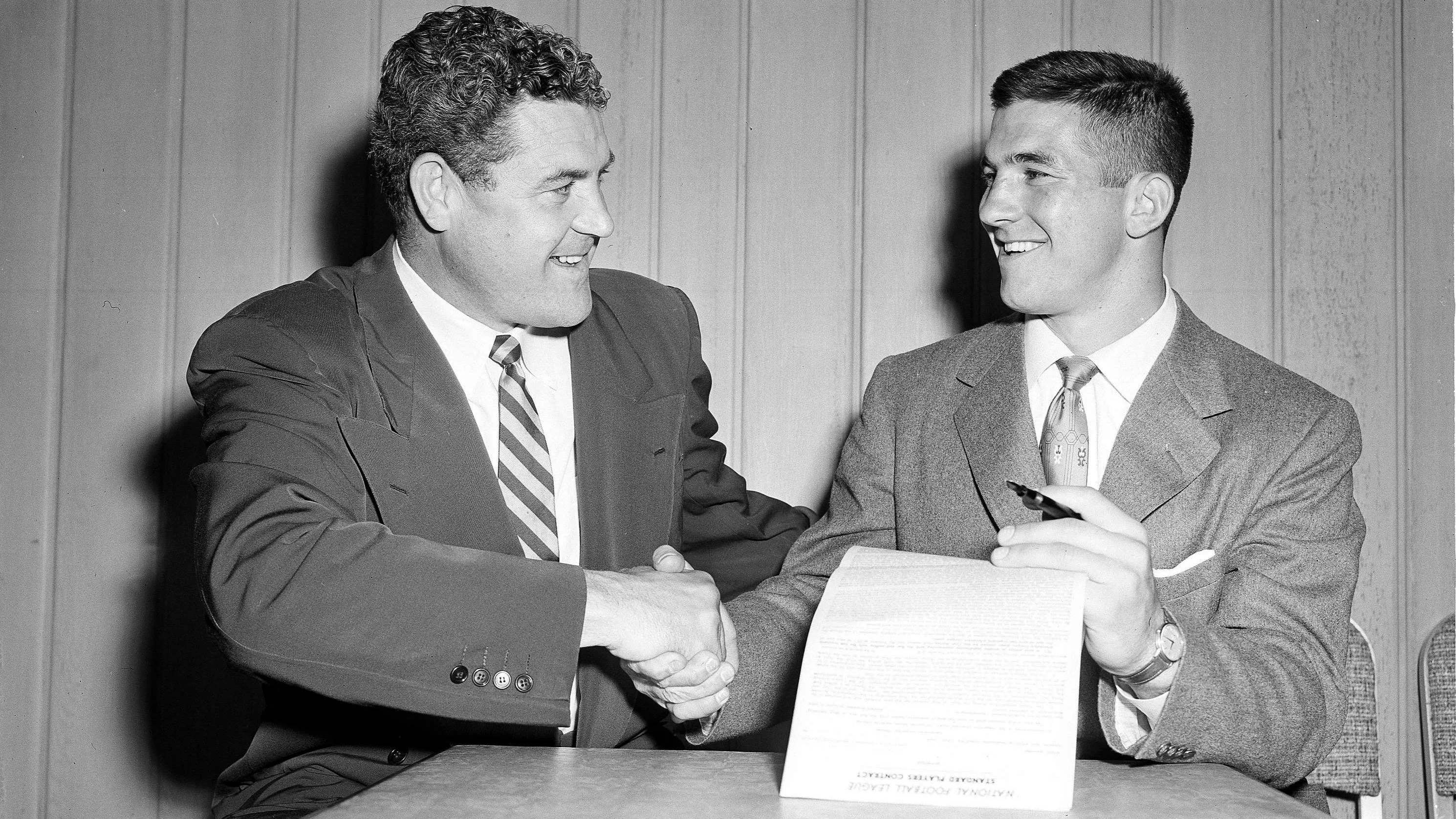 Les Richter, right, shakes hands with Joe Stydahar. (AP Photo/Harold P. Matosian)