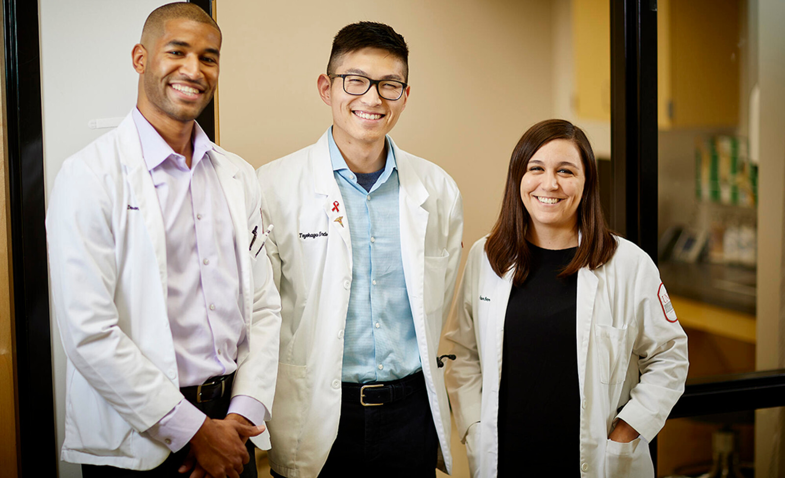 Dr. Faun Botor (right) alongside fellow charter class graduates Damien Medrano (left) and Toyokazu “Chris” Endo (center).
