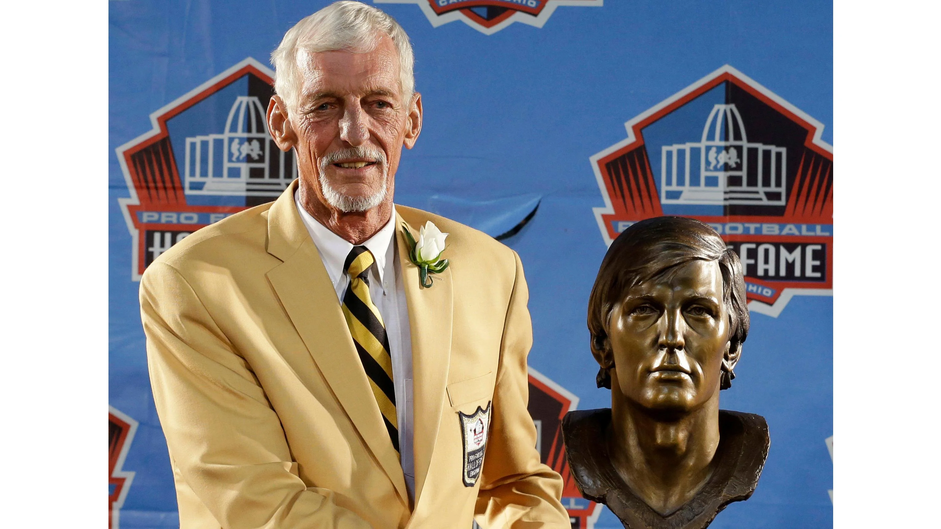 Ray Guy poses with his bust during the 2014 Pro Football Hall of Fame Enshrinement Ceremony. (AP Photo/Tony Dejak, File) - ASSOCIATED PRESS