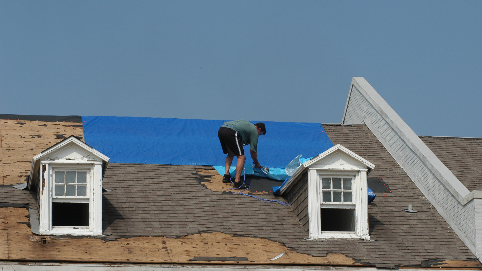 Homeowners in The Villages should ask their insurance company to arrange an inspection of their roof before letting a roofing company go up on the roof. - Stock image Homeowners in The Villages should ask their insurance company to arrange an inspection of their roof before letting a roofing company go up on the roof. - Stock image
