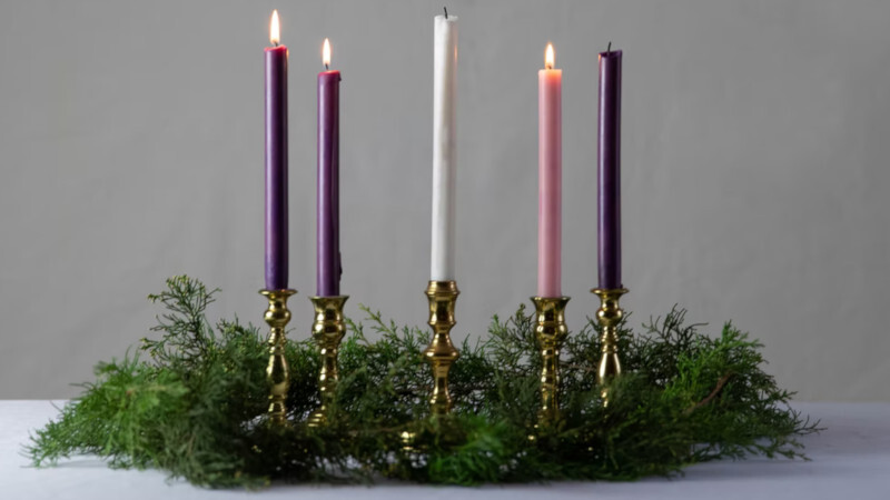 The candles on an Advent wreath burn bright in anticipation of the Lord's birth.