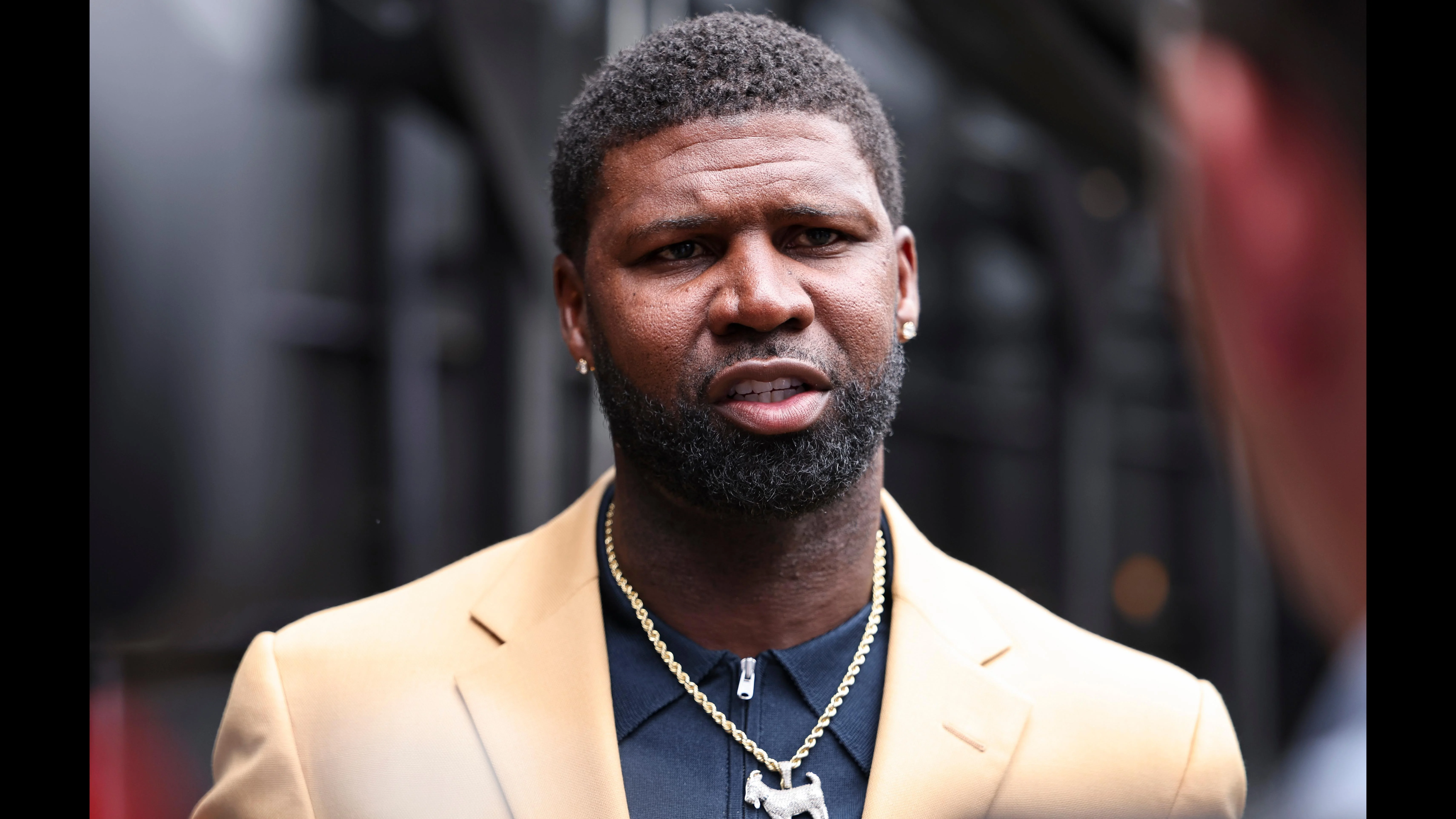 Devin Hester speaks on stage during his induction into the Pro Football Hall of Fame, Saturday, August 3, 2024 in Canton, Ohio. (Ben Liebenberg via AP)