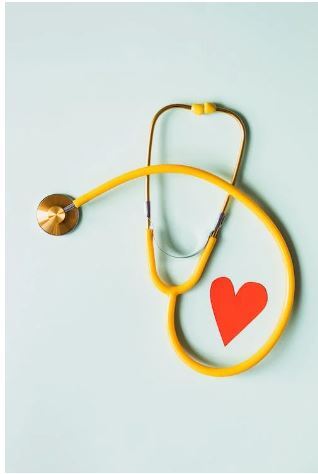Free to use  Medical stethoscope with red paper heart on white surface - Karolina Grabowska
