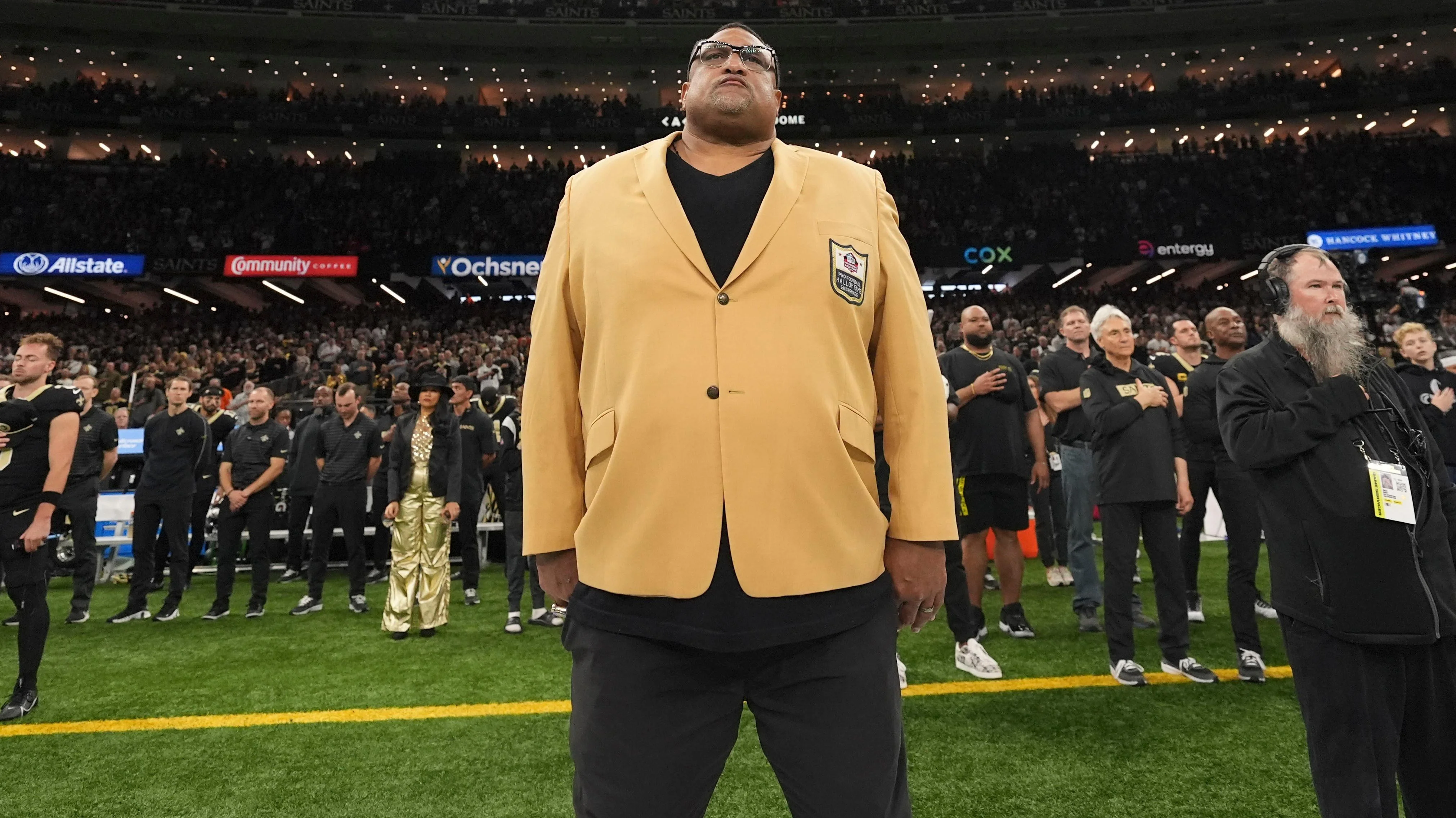 WIllie Roaf stands for the national anthem before the first half of an NFL football game against the Cleveland Browns in New Orleans, Sunday, Nov. 17, 2024. (AP Photo/Gerald Herbert)