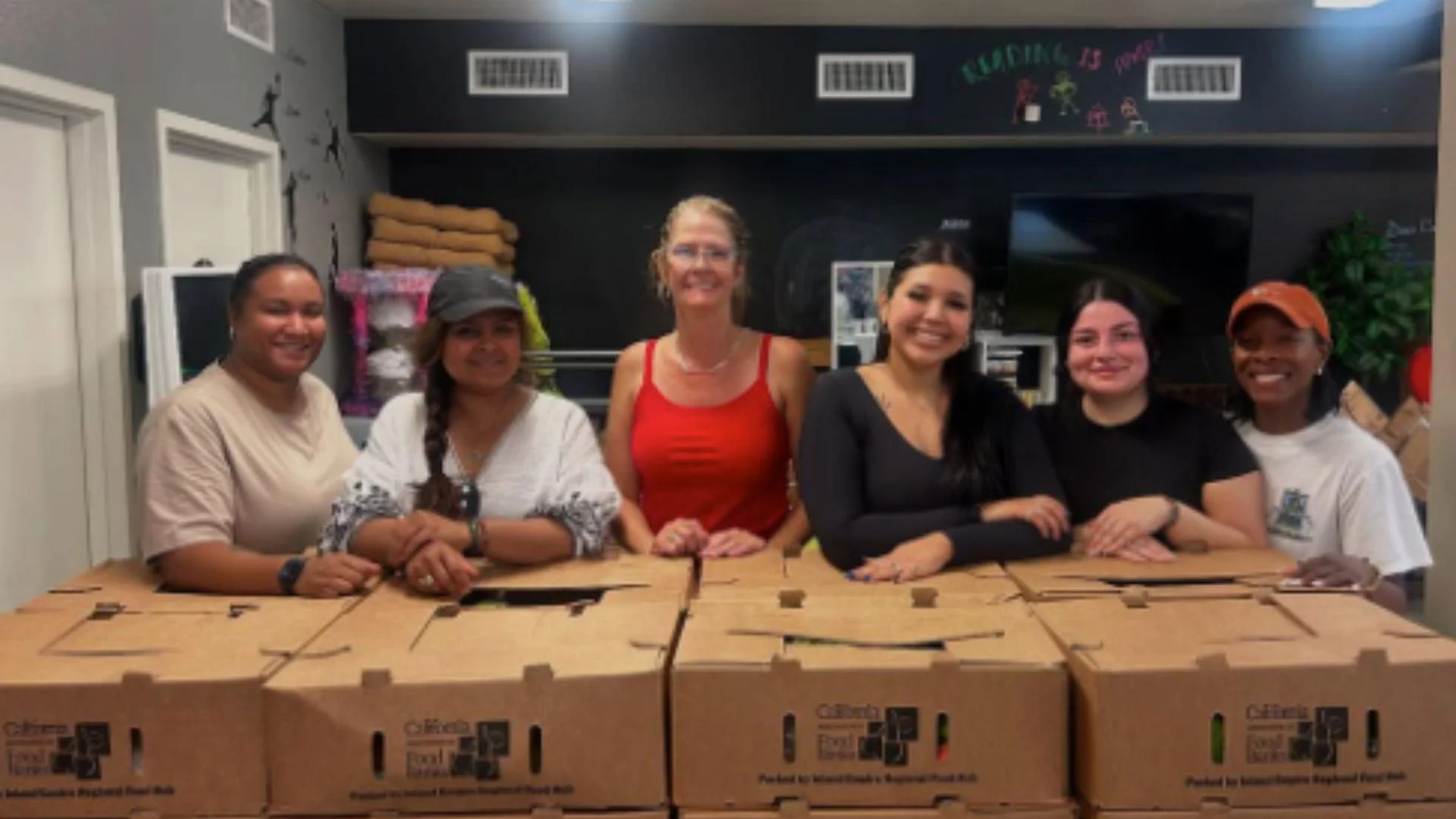 Members of the Women affinity group volunteering at a food distribution event with Hope Through Housing - proud2beksbd